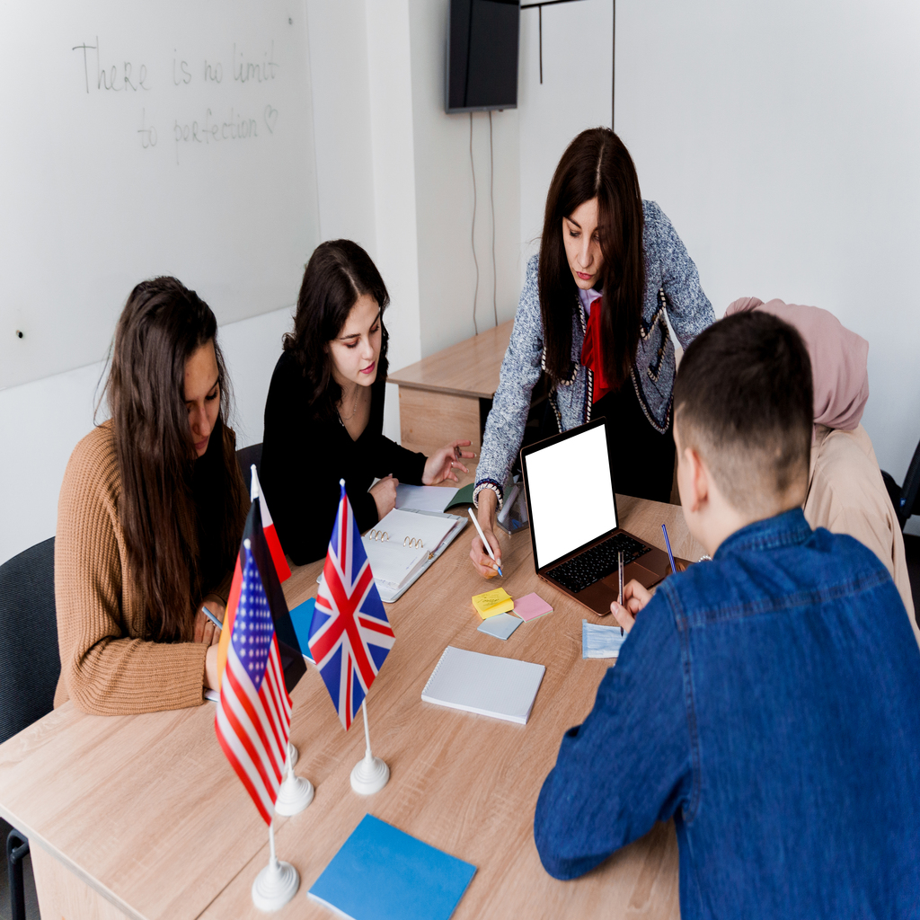 Teamwork. Working in multiethnic group of students. teacher study foreign languages together in class. Studing with laptop. Black handsome girl student study with white people together